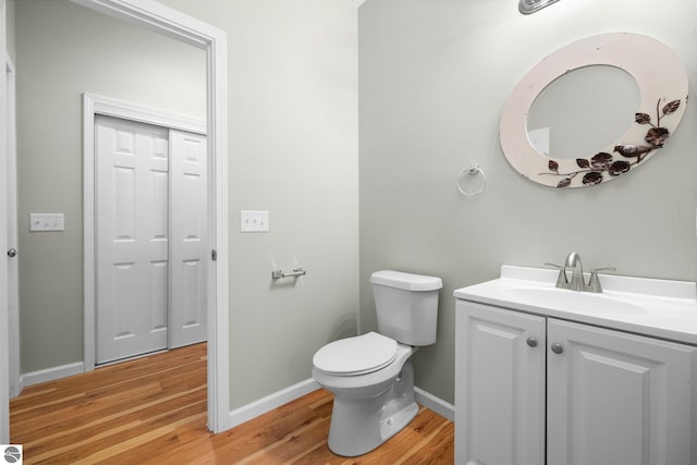 bathroom featuring hardwood / wood-style floors, vanity, and toilet