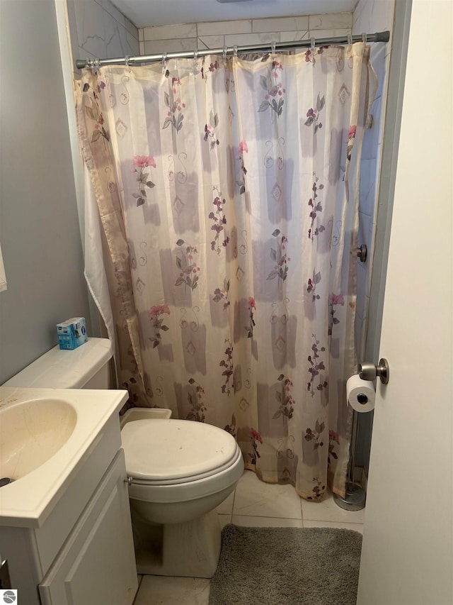 bathroom with tile patterned flooring, vanity, a shower with shower curtain, and toilet