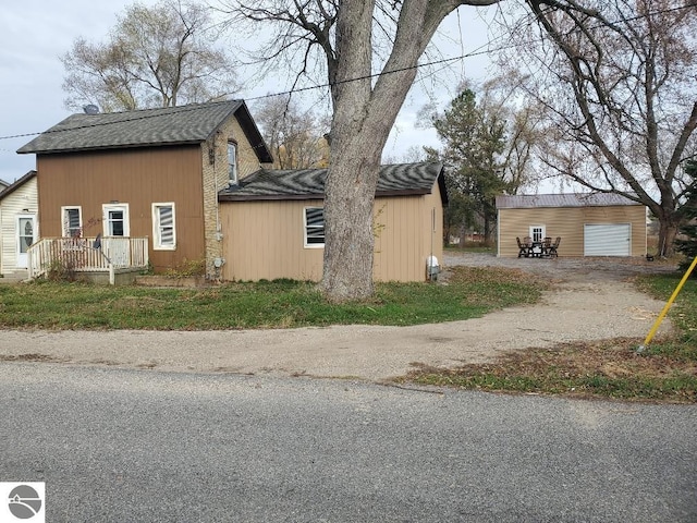 view of property exterior featuring a garage and an outdoor structure