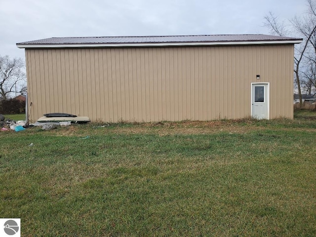 view of outdoor structure featuring a lawn