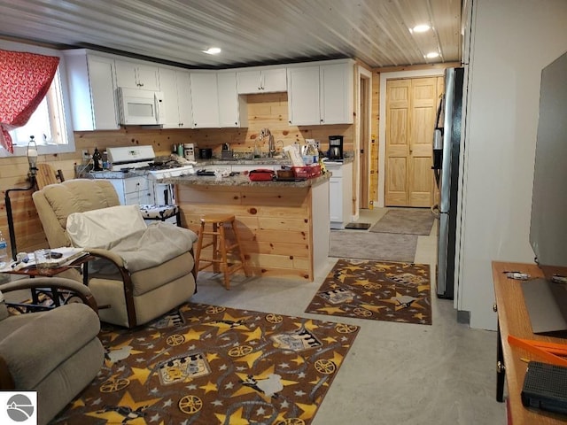 kitchen featuring sink, white cabinets, and white appliances