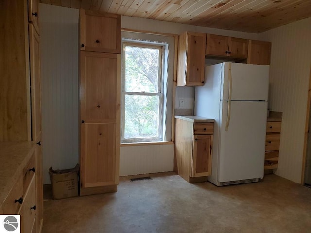 kitchen featuring white fridge and wood ceiling