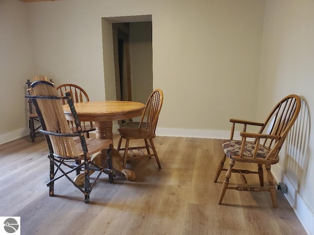 dining space with light hardwood / wood-style flooring