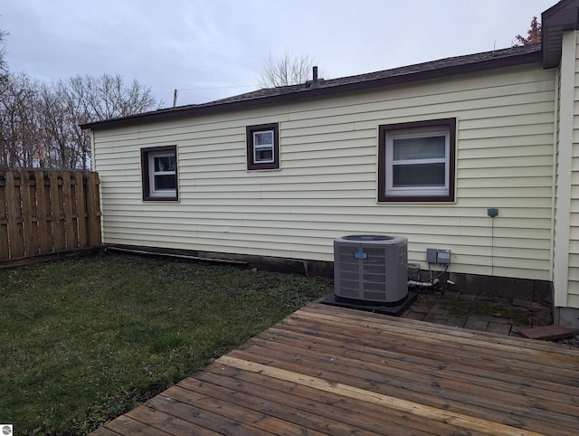 exterior space featuring central air condition unit and a yard