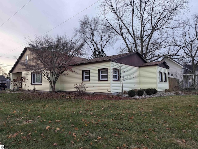 view of side of property with a yard