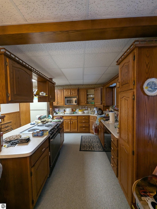 kitchen featuring carpet, a drop ceiling, white refrigerator, and black range with electric cooktop