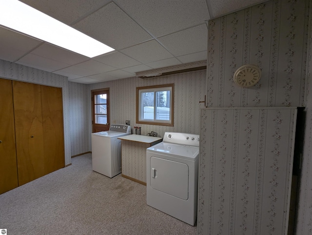 washroom featuring washer and dryer and light carpet