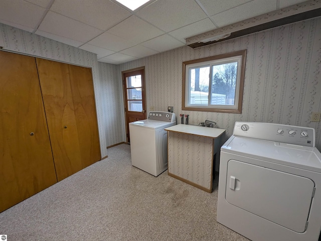 washroom featuring washer and dryer, light carpet, and a wealth of natural light