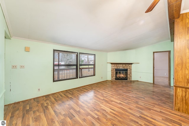 unfurnished living room with a fireplace, hardwood / wood-style flooring, and crown molding