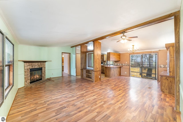 unfurnished living room featuring crown molding, a fireplace, ceiling fan, and light wood-type flooring