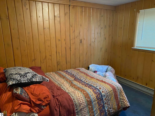 carpeted bedroom featuring wooden walls and a baseboard radiator