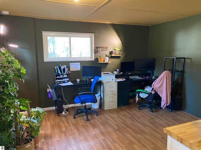 home office with wood-type flooring