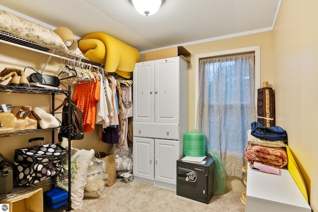 walk in closet featuring light colored carpet