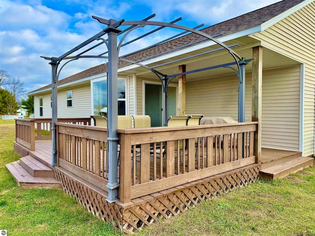 wooden terrace featuring a lawn