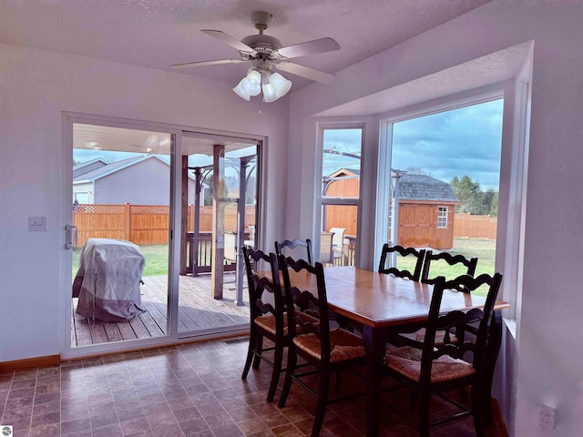 dining room with plenty of natural light, ceiling fan, and a textured ceiling