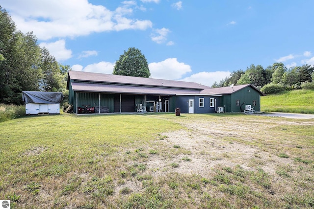 back of property featuring a lawn