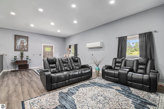 living room with hardwood / wood-style flooring and an AC wall unit