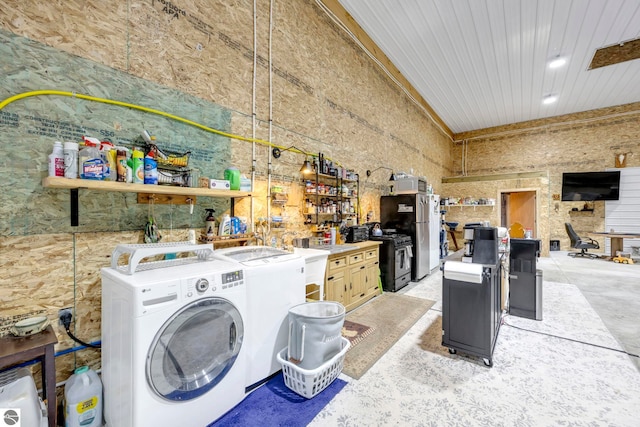 washroom featuring a towering ceiling and washer and clothes dryer