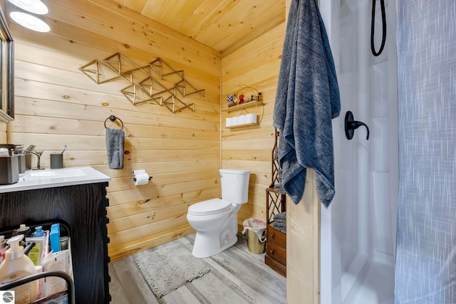 bathroom with hardwood / wood-style floors, curtained shower, and wooden walls