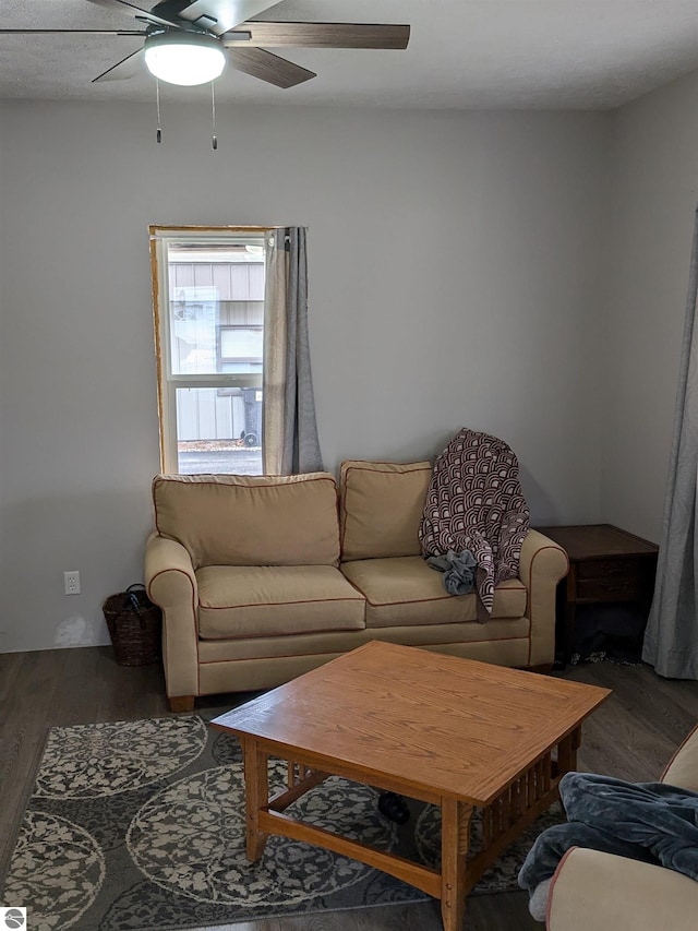 living room with ceiling fan and dark hardwood / wood-style flooring