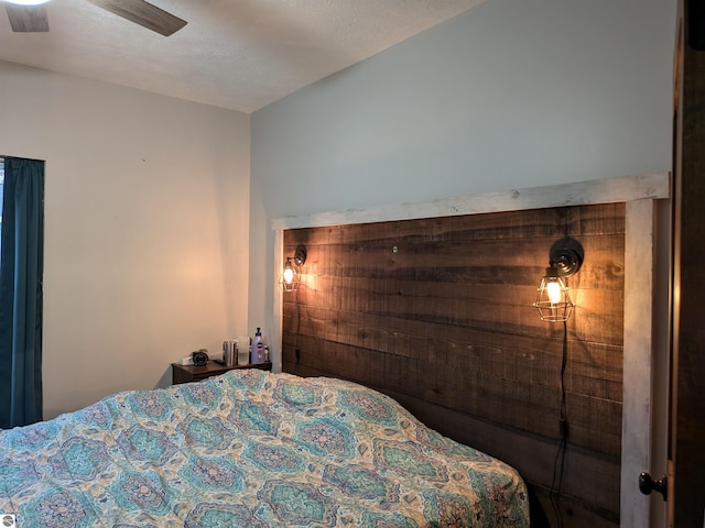 bedroom with ceiling fan and a textured ceiling