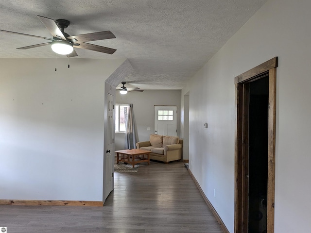 corridor featuring a textured ceiling and dark hardwood / wood-style floors