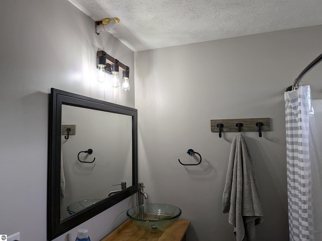 bathroom featuring vanity and a textured ceiling