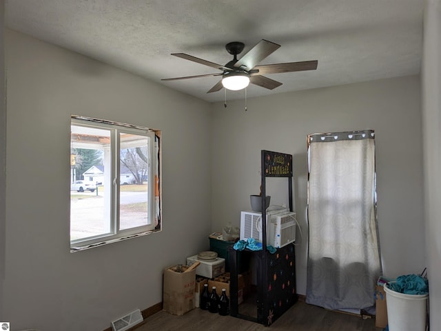 miscellaneous room with ceiling fan and dark hardwood / wood-style floors