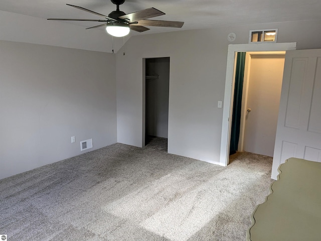 unfurnished bedroom with carpet flooring, ceiling fan, and a closet