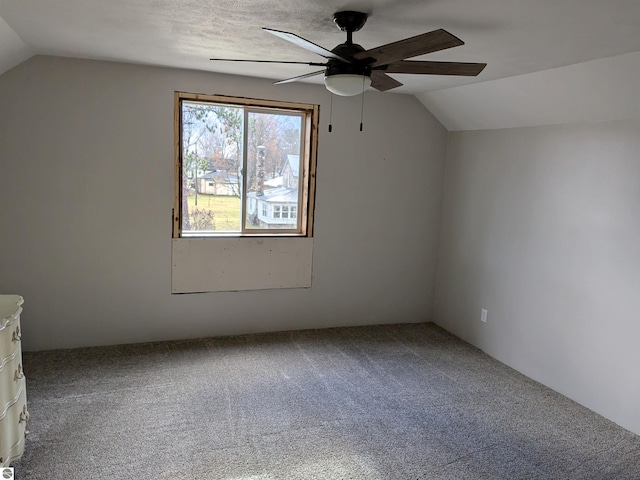 additional living space with ceiling fan, carpet, and vaulted ceiling