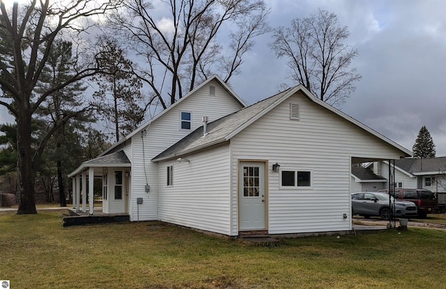 back of house with a lawn