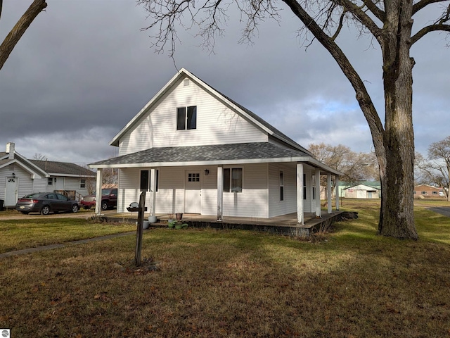 farmhouse with covered porch and a front yard