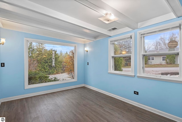 unfurnished room featuring beam ceiling and dark hardwood / wood-style flooring