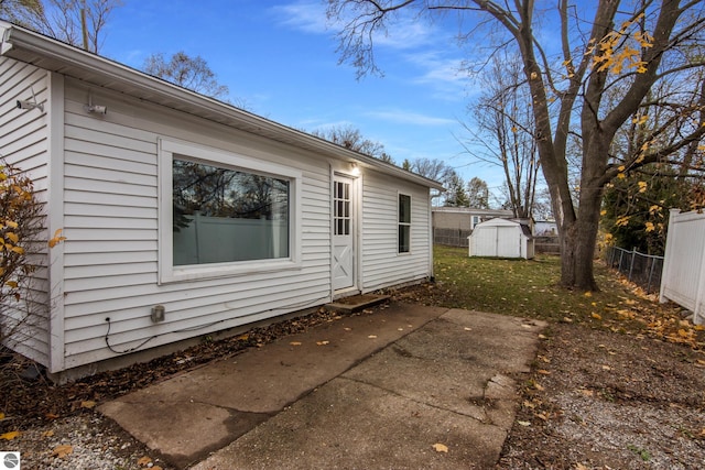 view of home's exterior featuring a storage unit and a patio area