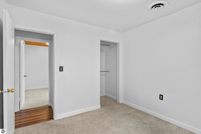 unfurnished bedroom featuring light colored carpet