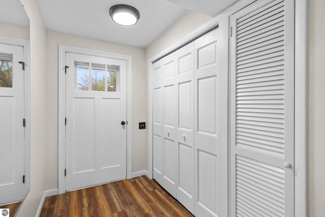 doorway to outside featuring dark wood-type flooring