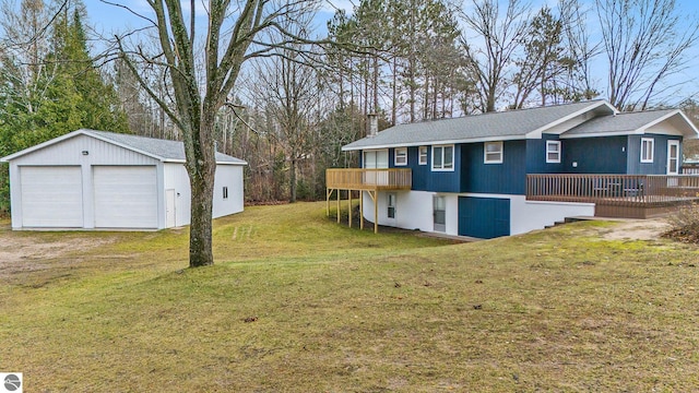 view of side of home with a yard, an outdoor structure, a deck, and a garage