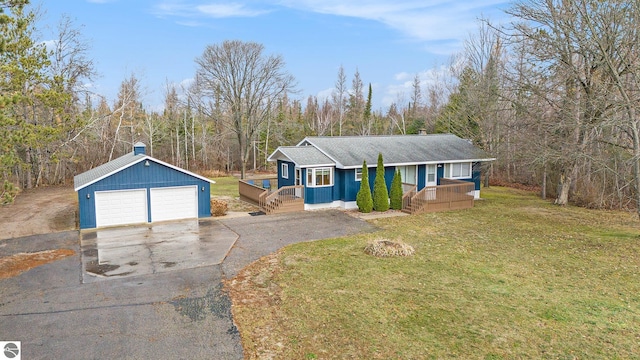 view of front of house with a front yard, a garage, an outdoor structure, and covered porch