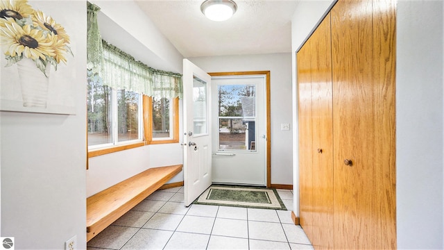 doorway with light tile patterned floors