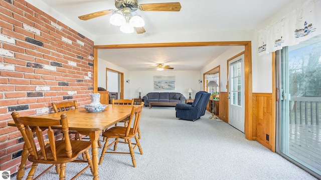 dining area featuring light colored carpet and ceiling fan