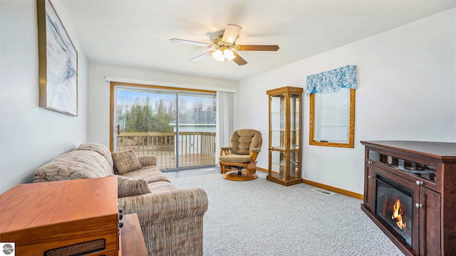 living room with ceiling fan and light colored carpet