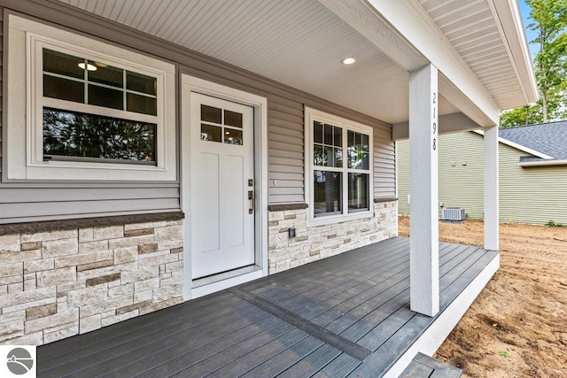 wooden terrace with cooling unit and covered porch