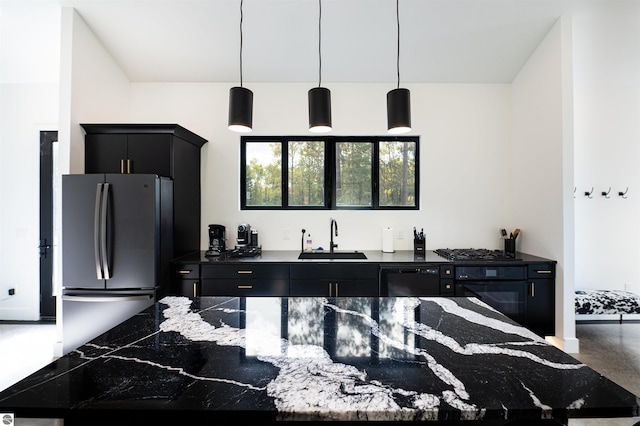 kitchen with decorative light fixtures, stainless steel fridge, sink, and black gas cooktop