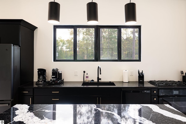 bar with hanging light fixtures, sink, black appliances, and plenty of natural light