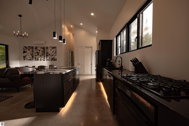 kitchen with sink, hanging light fixtures, stainless steel appliances, a kitchen bar, and a kitchen island