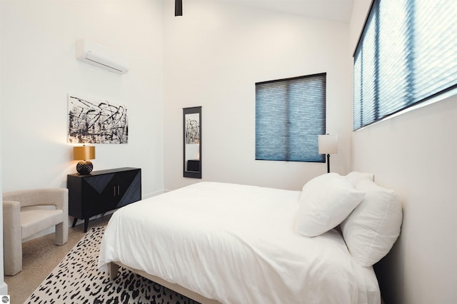 bedroom with a wall unit AC and carpet floors