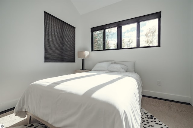 bedroom with carpet and vaulted ceiling