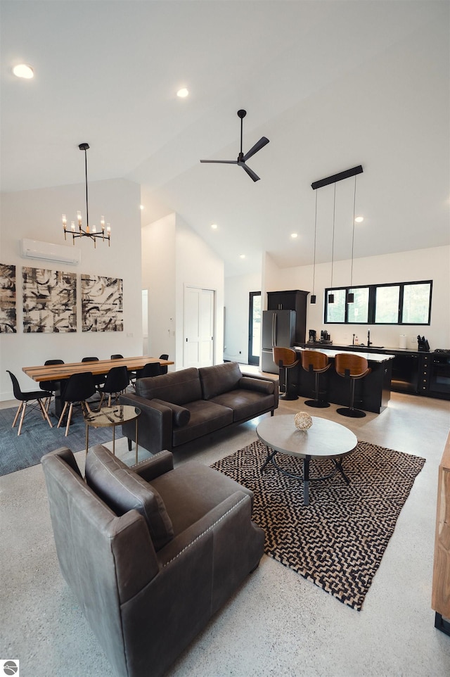 living room featuring ceiling fan with notable chandelier, an AC wall unit, and high vaulted ceiling