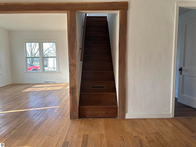 stairway featuring wood-type flooring