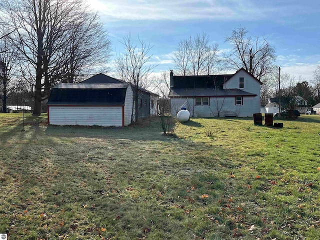 view of home's exterior featuring a storage unit and a lawn